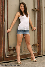 Brunette Girl Posing In Sexy Jeans Mini Skirt