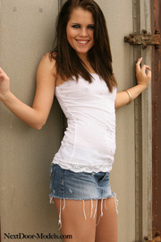 Brunette Girl Posing In Sexy Jeans Mini Skirt