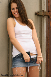 Brunette Girl Posing In Sexy Jeans Mini Skirt